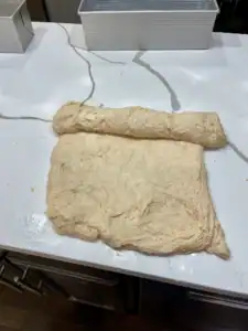 Rolling up sourdough sandwich bread shaping