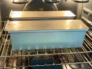 Tangzhong Sourdough Sandwich Bread baking with the lid on in the oven