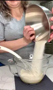 Adding sugar for brownie mixture